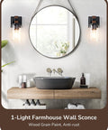 Top Tier Industrial Farmhouse Wall Sconces Set Of Two With Rustic Wood Grain Black Matte Finish And Clear Glass Shades in bathroom setting.