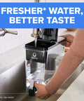 Person filling UltraMax Large Water Dispenser With Standard Filter BPA Free Reduces Copper Cadmium And Mercury Impurities Cuts Chlorine Taste And Odor In Your Kitchen Lasts About Two Months Or Forty Gallons Includes One Filter Big 27 Cup Capacity under faucet