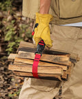 Person with yellow gloves carrying firewood secured by Beefy Outdoor Nylon Luggage Straps With Quick Release Buckle 1.5m Heavy Duty Camping Tie Down Straps For Securing Gear And Bundling Belts Two Pack Durable Travel Must Haves.