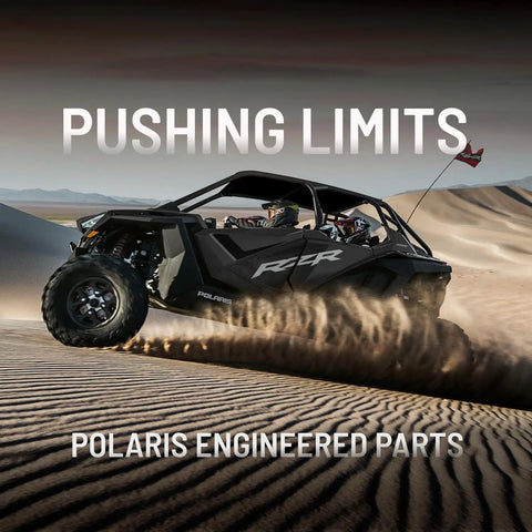 ATV driving through sand dunes with text 'Pushing Limits Polaris Engineered Parts'