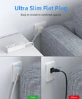 Flat Plug Extension Cord With 3 Outlets For Indoor Use behind couch, showcasing low profile design and space-saving feature.