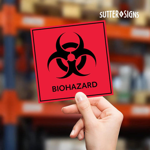 Heavy Duty Biohazard Stickers And Warning Decals Built Tough For Labs And Hospitals Includes Straight Up Essential Durable Vinyl Labels In A Solid Pack Of Ten For Zero Hassle Safety, showing a hand holding a bright red biohazard sticker.