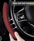 Slick And Hella Comfortable Premium Perforated Leather Steering Wheel Cover in wine red being installed on a vehicle's steering wheel.