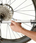 Derailleur Hanger Alignment Gauge Tool for 20 to 29 Inch Bikes in use for wheel tuning, made of stainless steel, ensuring smooth shifts.
