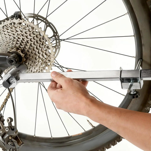 Derailleur Hanger Alignment Gauge Tool for 20 to 29 Inch Bikes in use for wheel tuning, made of stainless steel, ensuring smooth shifts.