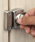 Hand turning Tough As Nails Zinc Alloy Reversible Door Latch With Push Pull Bolt Lock on wooden door for secure access.