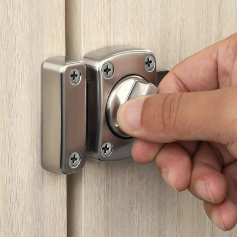 Hand turning Tough As Nails Zinc Alloy Reversible Door Latch With Push Pull Bolt Lock on wooden door for secure access.