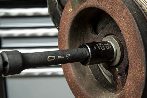 Close-up of 65 Piece 1/2 Inch Drive Impact Socket Set Standard And Deep SAE And MM Off Corner Loading in use on car wheel.