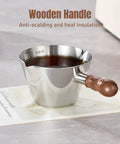 Close-up of espresso cup with wooden handle, part of 2 Piece Espresso Cup Set With Handle For Barista Level Pouring, 3.4 Oz Stainless Steel Cups