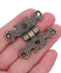 Vintage H Shape Zinc Alloy Hinges For Small Cabinets And Wooden Gift Boxes shown on palm