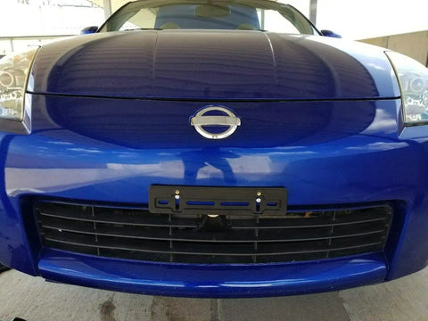 Close-up of Nissan with front license plate mounting kit with tag holder adapter for Nissan all models flat bumper design left or right mount includes six screws and two built in nuts plug and play premium car set accessories easy install