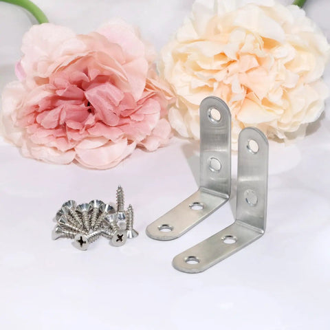 Stainless Steel Angle Corner Bracket With Screws 10 Pack 50x50mm Right Angle Braces for DIY furniture repair next to flowers