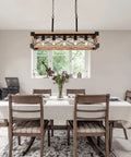 Farmhouse Linear Pendant Light For Kitchen Island And Dining Room, 5 Light Rustic Wood Grain Industrial Chandelier over dining table.