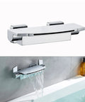 Black Wall Mount Waterfall Tub Faucet with High-Flow Tub Filler and Wide Spout installed on bathroom wall