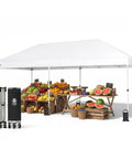 Pop Up Canopy Tent 10x20 Instant Outdoor Shelter For Parties And Weddings, white canopy with fruits underneath, sturdy steel frame.