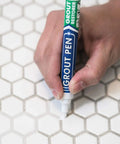 Hand using white tile grout paint marker for grout color and sealer waterproof narrow 5mm tip 7mL on hexagon tiles.