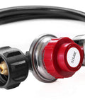 Close-up of propane regulator with gauge and red adjustment knob on a black 4 ft hose; brass fittings visible