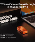 Straight Up Blazing Fast M.2 NVMe SSD Enclosure Built For Power Crews Who Want Zero Lag Data Transfers, sleek orange chassis next to laptop.