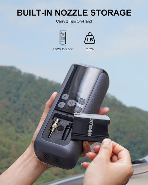 Person holding Dual Cylinder Tire Inflator with Auto Shut Off, showing built-in nozzle storage with tips visible.