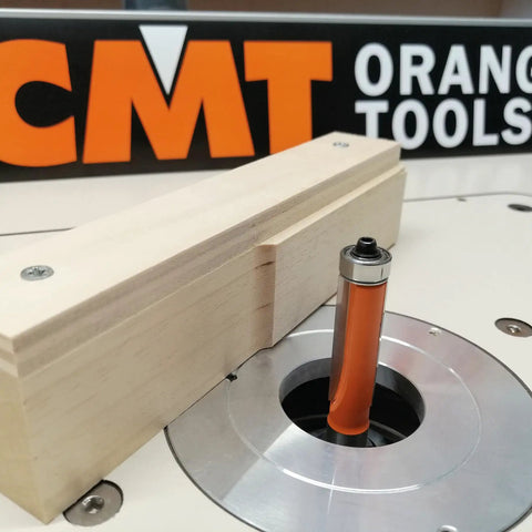 Heavy Duty Half Inch Shank Flush Trim Router Bit With Matching Ball Bearing in router table with wooden template.
