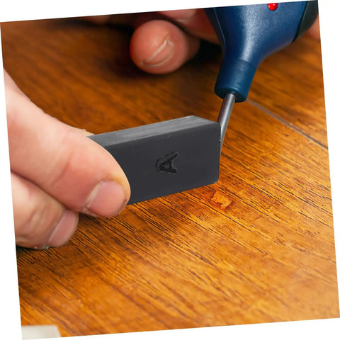 Wood Floor Repair Kit With Wax Blocks For Quick Scratch Fixes On Hardwood Vinyl And Laminate Surfaces For An Easy Portable Restoration Tool For Home Repairs And Touch Ups being used on a scratch