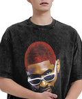Person wearing a black t-shirt with a graphic of a person with red hair and sunglasses.
