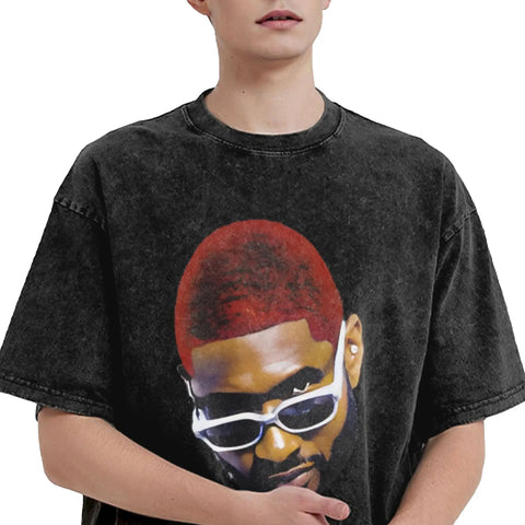 Person wearing a black t-shirt with a graphic of a person with red hair and sunglasses.
