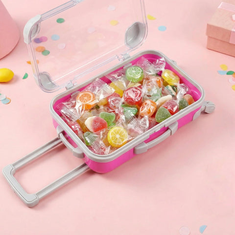 Pink mini suitcase party favor box with wheels, open lid, filled with wrapped candies