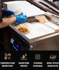 Person using vacuum sealer with Heavy Duty High Temperature PTFE Tape For Vacuum Sealer Machine 1 Inch By 33 Feet Heat Resistant Up To 500 F 260 C Perfect For Sealing, Packaging, Thermoplastics, Electronics And Electrical Jobs.