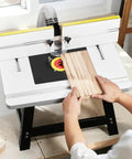 Benchtop Router Table With 24 by 15.7 Inch MDF Top And Adjustable Fence, sturdy metal base with wood being shaped.