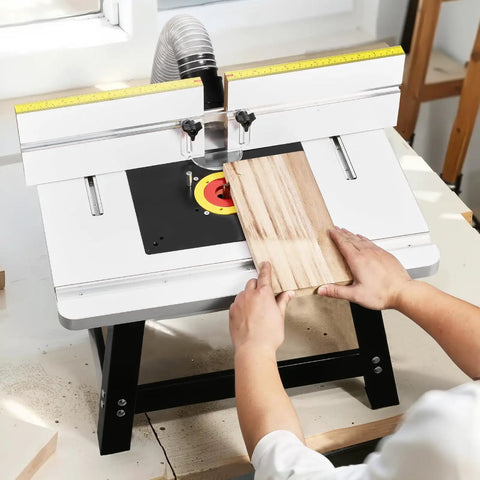 Benchtop Router Table With 24 by 15.7 Inch MDF Top And Adjustable Fence, sturdy metal base with wood being shaped.