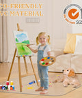 Child painting on an easel with dog on clear chair mat on hardwood floor, showcasing eco-friendly PVC material.