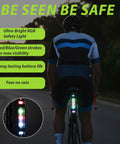 Cyclist on road bike showing waterproof tail light from 6 Piece Bike Accessories Kit For Men And Women Including Cycling Bag Bicycle Bag Gloves Waterproof Tail Light Ride Ready Mountain Road Gear And A Touch Screen Phone Holder With Responsive Window glowing in dark surroundings.