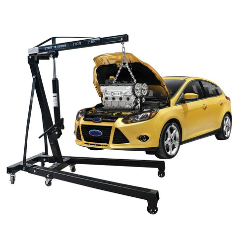 Heavy Duty 2 Ton Hydraulic Engine Hoist lifting engine from a yellow car, steel construction, garage essential for mechanics.