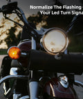 Harley compatible LED turn signal load equalizer and stabilizer installed on motorcycle, keeping signals solid, no flashing issues.