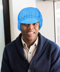 Gotta Love These Five Pack Anti Static Work Caps Designed With Breathable Mesh To Keep Your Head Fresh In Cleanrooms And Workshops Lightweight Blue Scrub Hats That Hold Up Through Heavy Daily Use worn by a smiling man.