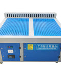 Heavy Duty Industrial Dust Collector Workbench With Side Suction Floor, 4 Horsepower Motor Kicks Welding Dust And Smoke Like A Champ, Comes Packed With Two Polyester Filters And Auto Clean Cycling. Industrial blue workbench with perforated top.