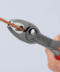 TwinGrip Pliers 10 Inch with Front and Side Gripping Jaws holding a wire, showcasing slim head and red handle for leverage