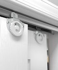 Richelieu Hardware 14660BC 60 Inch Bypass Door Hardware Kit with zinc and brass finish, installed on white closet doors.