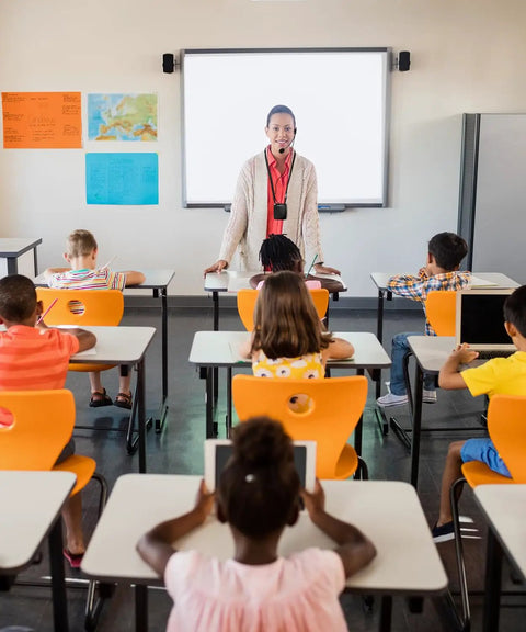 Teacher using Portable Voice Amplifier With Headset Microphone For Speaking On The Go Rechargeable Mini PA System in classroom