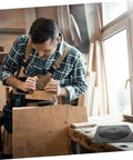 Man using tools to install Heavy Duty Steel Table Leg Connectors To Kick The Wobble Out Of Wobbly Couches And Wooden Dining Tables Fast