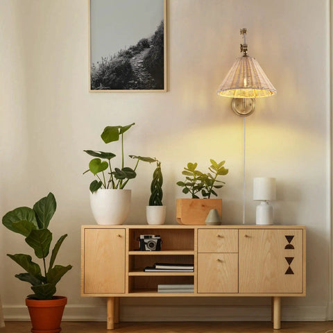 Rattan Wrapped Wall Sconce With Adjustable Swing Arm And Foldable Vintage Bedside Light Gold Finish With Wicker Shade Plug In Or Hardwire Brass Reading Lamp For Living Room Or Bedroom in living room setting.