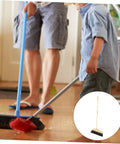 Straight Up Solid Horsehair Broom With Long Grippy Handle And Soft Pine Bristles used by a person and child for cleaning hardwood floor.