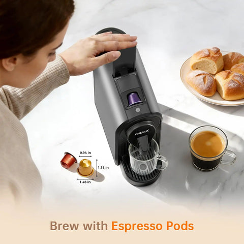 Top Tier Espresso Maker For Nes Pods With 20 Bar Italian Pump And One Touch Brewing 1400 Watt Automatic Coffee Brewer In Sleek Gray brewing coffee with a glass cup and espresso pods