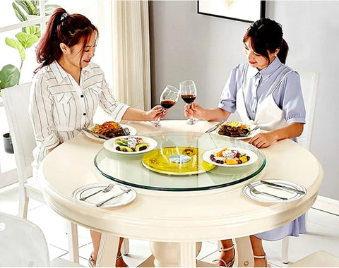 Two women dining with a Glass Turntable Serving Tray for Dining Tables 70 to 120 cm Rotating, Explosion Proof Tempered 10mm Glass.