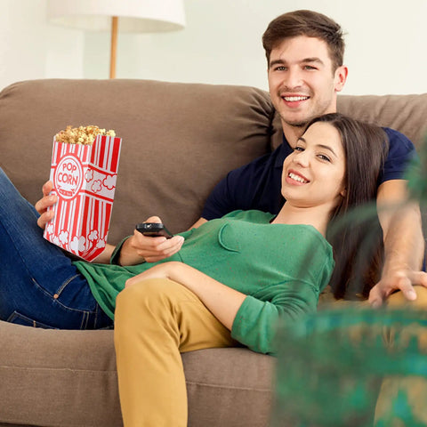 Couple on sofa with Heavy Duty Paper Popcorn Bags 1 Oz Individual Servings 500 Pack For Popcorn Machines Small Mini Bags.