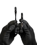 Compact Self Adjusting Pipe Vise With Sweet Ratchet Action And Nifty Contoured Grip For Tight Spots showing two different sizes held in gloved hands.