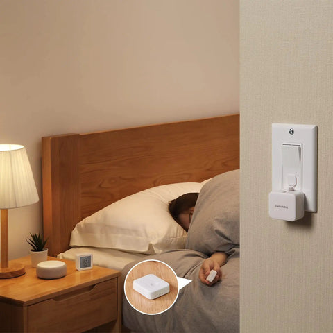 Bedroom setting with Smart Button Pusher For Rocker Switches And One Way Buttons, Bluetooth Control From Your Phone, No Wiring Needed.