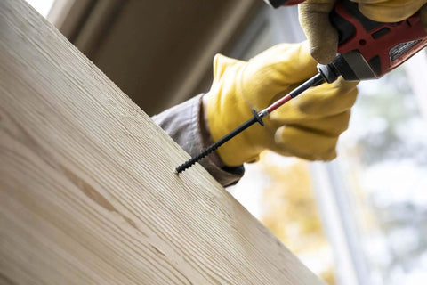 One Quarter Inch By Four Inch T Star Washer Head Exterior PowerLag Screw being drilled into wood, showing faster driving threads.