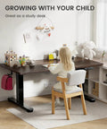 Top Notch ErGear Low Height Adjustable Electric Standing Desk 48 X 24 Inches For Kids with a child studying at home.